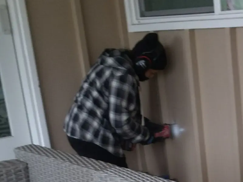 Professional electrician installing an exterior outlet in Eagle